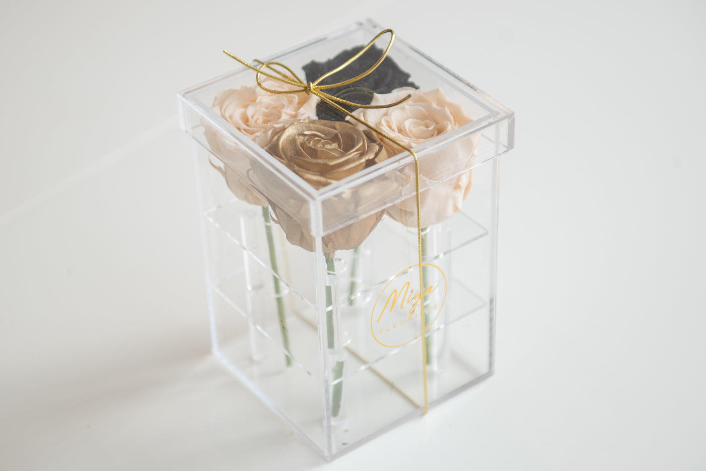 Four roses in an acrylic box image 0