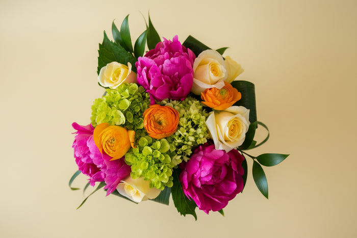 Colorful bouquet of flowers on a beige background