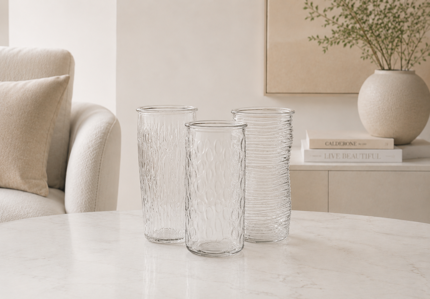 Clear glass vases on a table in a minimalistic living room setting.